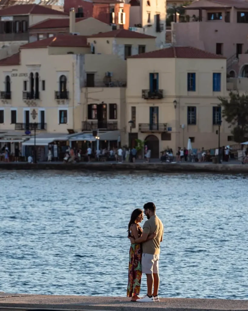 Couple standing by the water at the Old Harbor of Chania in Crete