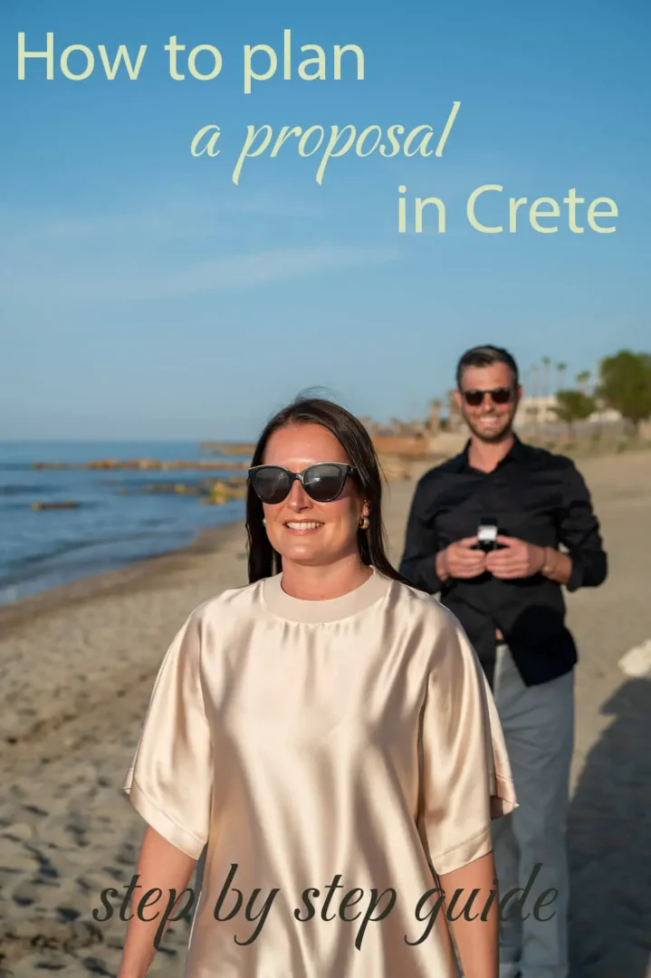 Surprise proposal on a beach in Crete with groom holding ring behind partner
