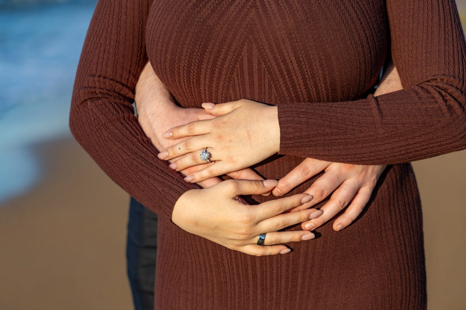 Close-up of engagement ring on woman's hand during a beach proposal in Crete