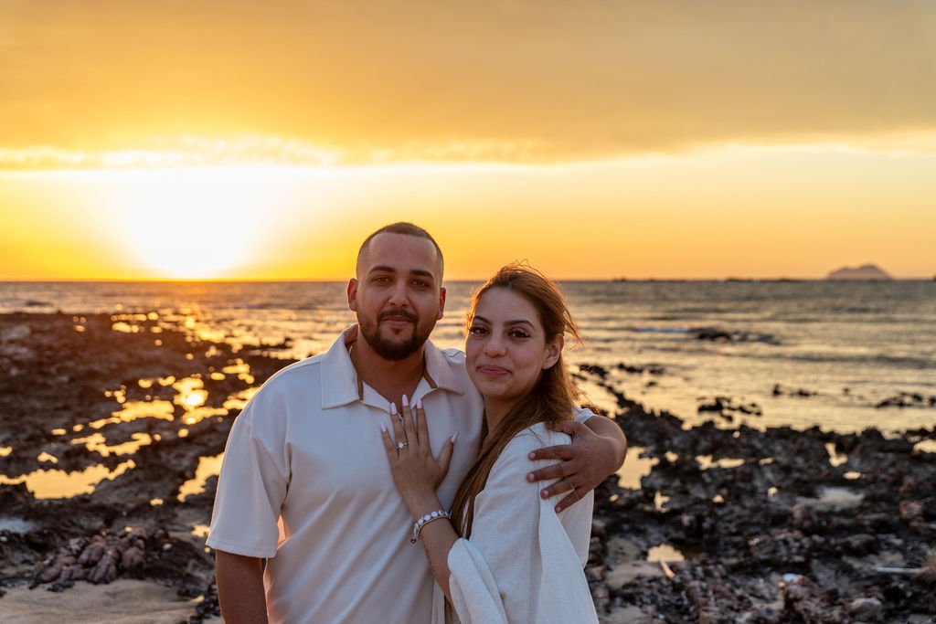 Newly engaged woman showing her engagement ring after a sunset proposal in Falassarna, Crete.